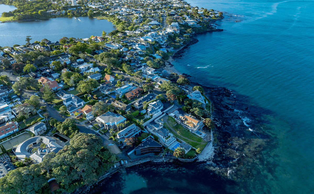 Auckland coastal suburb aerial view with residential housing, highlighting urban development, land use, and housing growth potential in New Zealand
